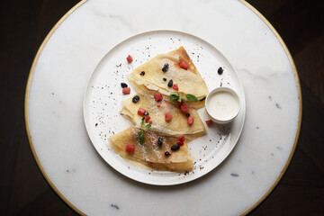 Crepes, apple pancake or caramelized apple crepe with yoghurt cream
