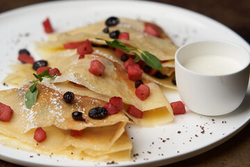 Crepes, apple pancake or caramelized apple crepe with yoghurt cream