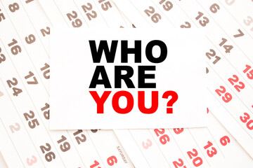 text WHO ARE YOU on a sheet from Notepad.a digital background. business concept . business and Finance.