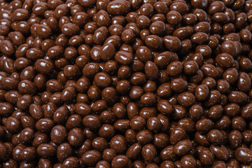 Brown dragee, chocolate covered nuts, background