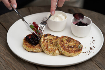 Cottage cheese pancakes with berry jam and sour cream