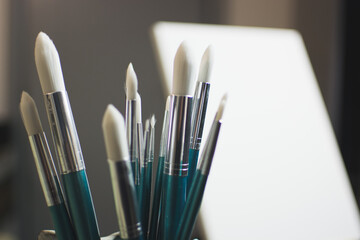 Paint brushes, with an oil background