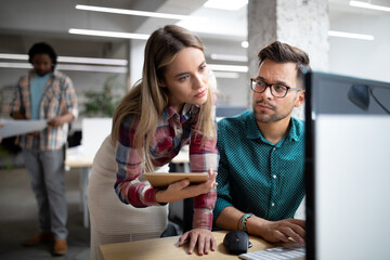 Group of business people and software developers working as a team in office