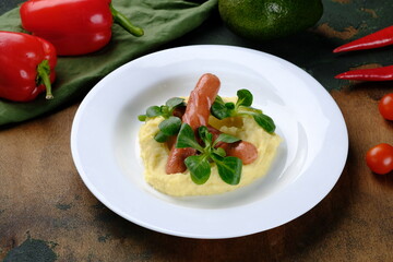Sausages with mashed potatoes on a dark wooden background.