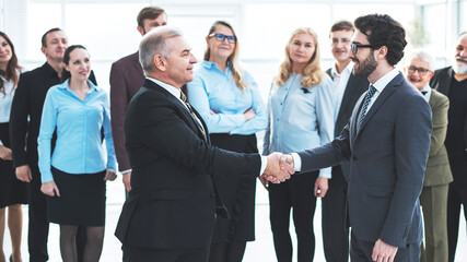 happy business partners shaking hands. the concept of cooperati