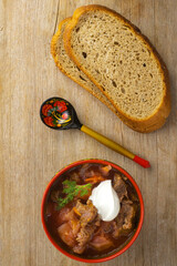 Borscht russian ukrainian traditional vegetable cabbage beetroot red soup, natural wooden background