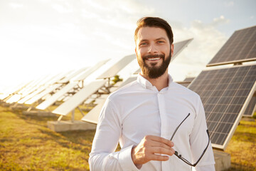 Cheerful male investor on solar farm