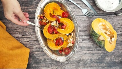 Roasted slices of pumpkin and cherry tomatoes on a silver tray
