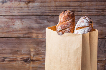 bread rolls tucked into paper bag