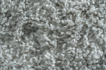White fluffy textile carpet with long fleece background on room floor