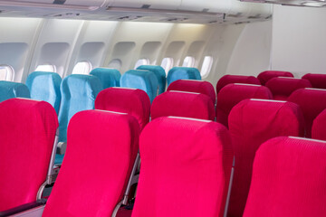 Empty passenger seat in the economy class of airplane in the cabin. Interior of airplane with walking the aisle. Slow motion.