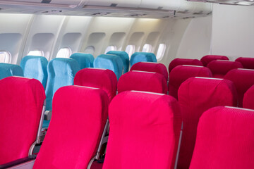 Fototapeta premium Empty passenger seat in the economy class of airplane in the cabin. Interior of airplane with walking the aisle. Slow motion.