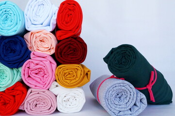 Obraz na płótnie Canvas multi-colored fabric rolled into rolls, thin knitwear