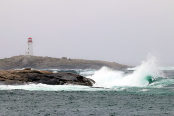 The iconic Peggy's Cove Lighthouse located in Nova Scotia has withstood many storms and crashing waves on the granite rocks that it stands on.