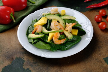 Spinach spinach spinach with shrimp on a dark wooden background