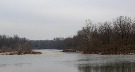 The flowing river on a overcast winter day.