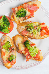 open sandwich with prosciutto mozzarella tomatoes kitchen table shallow focus (1)