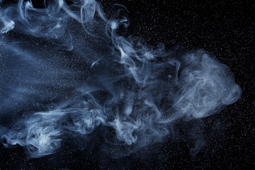 Abstract white smoke moves on black background. Beautiful swirling gray smoke.