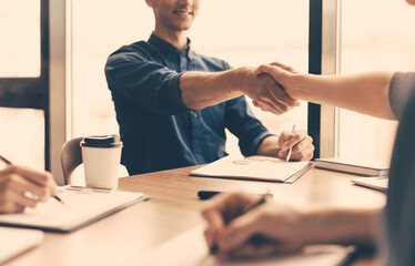 close up. confident handshake of business people sitting at the office table.