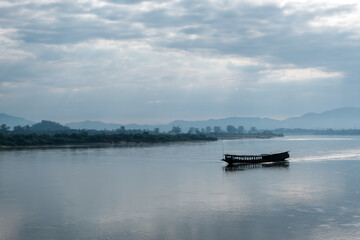 Cargo ships sailed in the middle of the Mekong River.