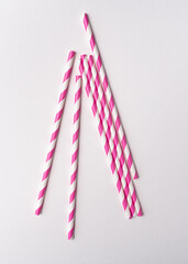 Drinking Striped Pink paper straws on white background