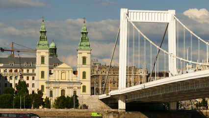 Fototapeta na wymiar The elegant Elizabeth Bridge over river Danube and the Budapest Inner-City Mother Church of the Blessed Virgin in Budapest, Hungary