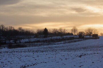 sunset over the snowy fields 