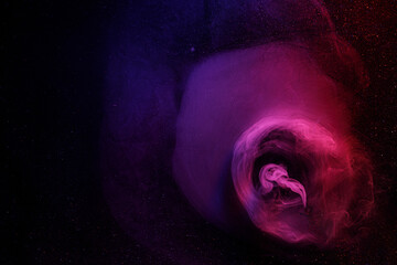 Abstract purple smoke moves on black background. Beautiful swirling smoke.