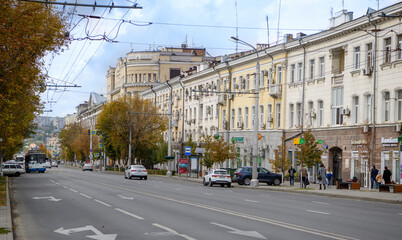 Naklejka na ściany i meble Autumn has come to the city.Pedestrians and vehicles move along the street Bolshaya Sadovaya