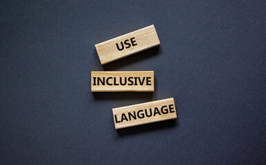 Use inclusive language symbol. Wooden blocks with words 'Use inclusive language'. Beautiful grey background. Business and use inclusive language concept. Copy space.