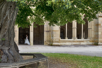 Maulbronn Monastery from outside with a bride in a white dress, Germany: Maulbronn is a former Cistercian abbey and one of the best-preserved in Europe, was named a UNESCO World Heritage Site in 1993.
