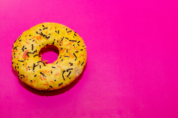 Colorful glazed donuts on a crimson background