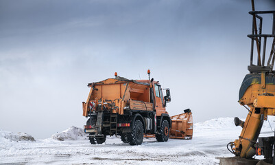 Snow plough truck cleaning a road through the mountains after winter massive snowfall