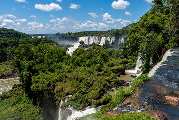 Obraz na płótnie Canvas Wonderful vivid landscape of Iguazu Falls with water streams falling down among verdant vegetation