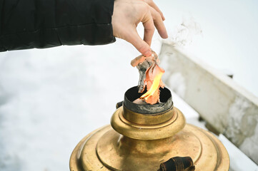 Heating samovar. Russian traditional tea machine. Smoke and flame from chimney. Close-up.
