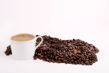 a cup of coffee on top of coffee beans