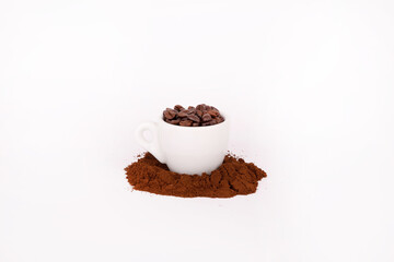 a cup of coffee on top of coffee beans