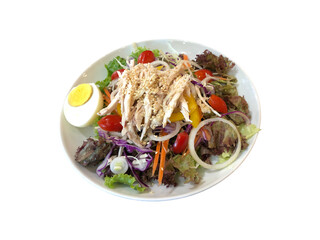 Delicious salad with chicken, vegetables, tomatoes, egg, onion, carrot, sesame
