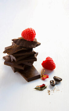 Chocolate Is Stacked Together. There Are Red Cherries On Top And Coffee Seed, With White Background.