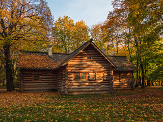 A cozy wooden log cabin in the autumn forest.