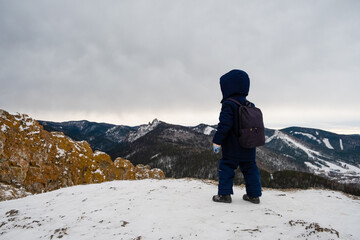 boy traveler on top of a cliff