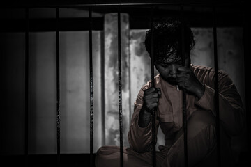 Asian man desperate at the iron prison,prisoner concept,thailand people,Hope to be free,Serious...