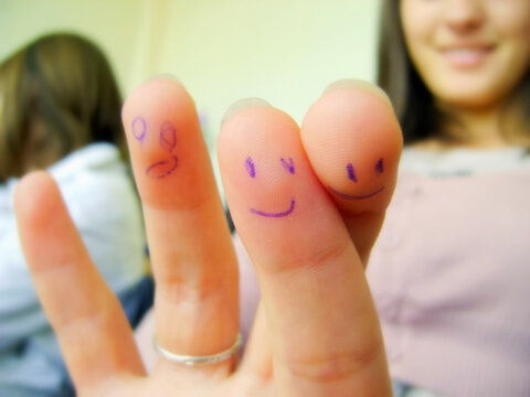 Smiles painted on the fingers with ballpoint pen.