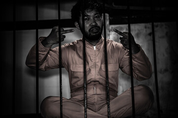 Asian man desperate at the iron prison,prisoner concept,thailand people,Hope to be free,Serious...