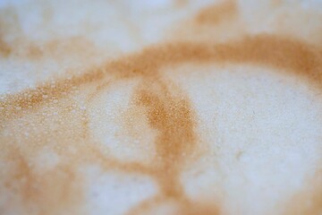 Drawing of a woman's face on a foam coffee latte in a glass created by a 3D printer