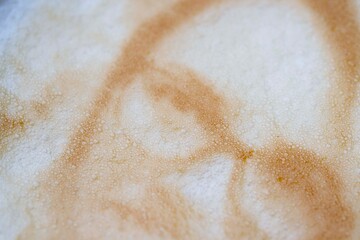 Drawing of a woman's face on a foam coffee latte in a glass created by a 3D printer