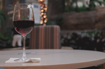 glass of red wine on a table Red wine is a type of wine made from dark-colored grape varieties.  color of the wine can range from violet, or brick red for mature wines and brown for older red wines.