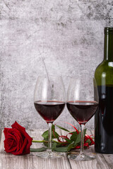 rose single flower and two red wine glasses