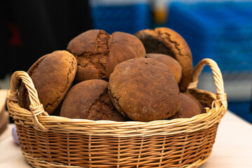 Basket of toasted buns. A wicker basket with a lot of bread in it.