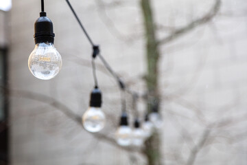 illumination on the street, electric bulbs on the wire. Lighting concept